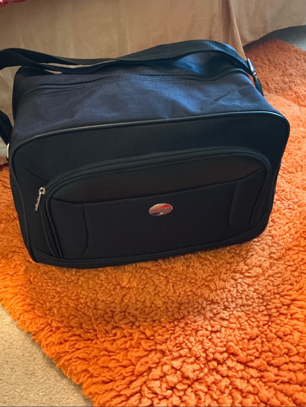 American Tourister Black Travel Duffel Bag - Front Pocket, Back Attachment.